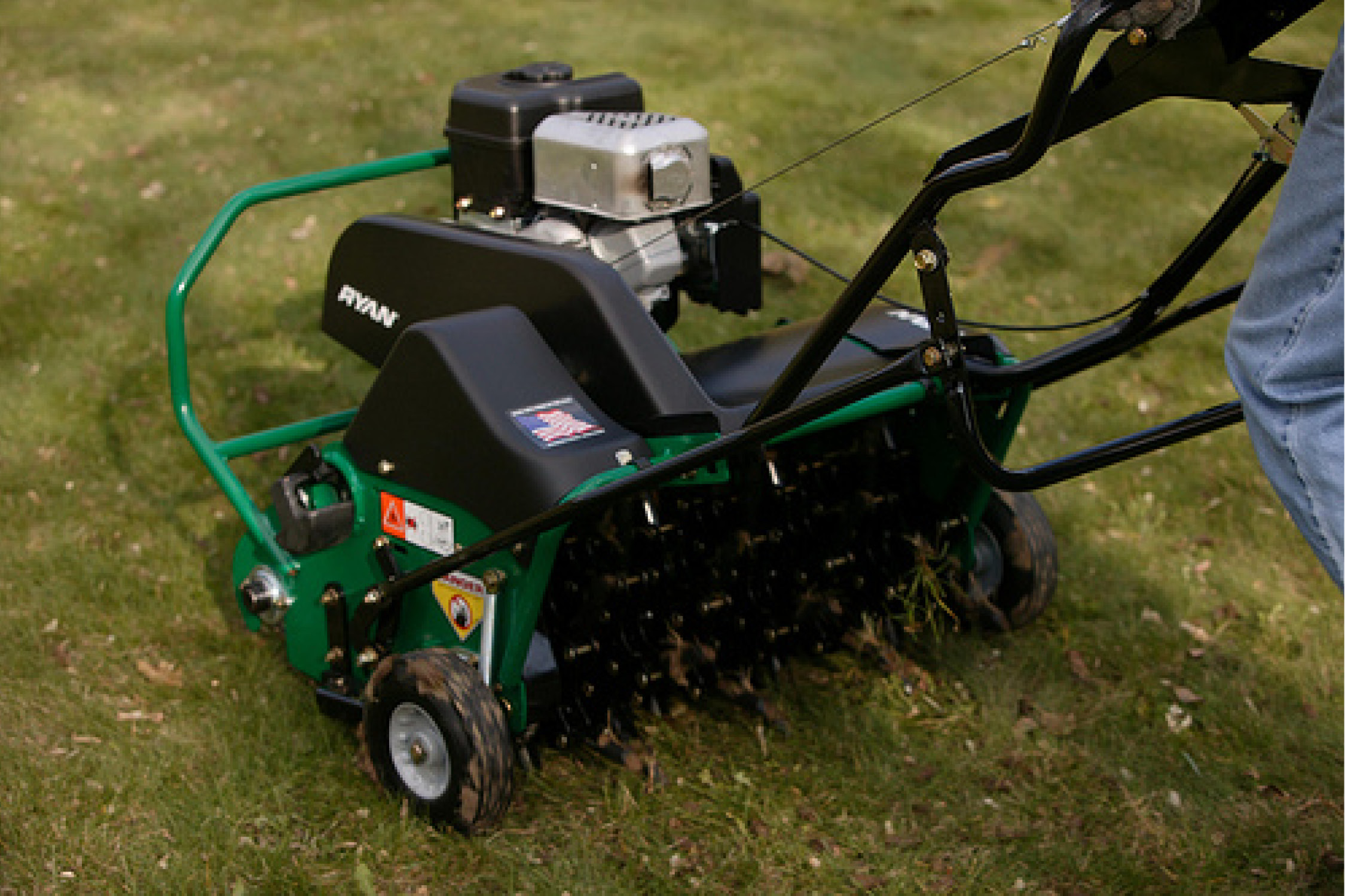 BML crew running a slice seeder across a residential lawn in Western Massachusetts